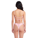 Woman wearing a pink bikini with criss-cross straps on a white background