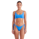 Woman wearing a blue bikini on a white background
