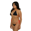 Woman wearing a black and orange bikini on a white background
