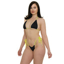 Woman wearing a black and yellow bikini on a white background
