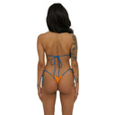 Woman wearing a blue and orange bikini on a white background