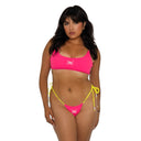 Woman wearing a pink bikini with yellow strings on a white background
