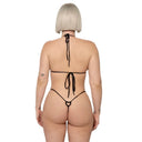 Model wearing Black Infatuation micro thong bikini bottom, back view
