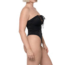 Model wearing Black Snatched tie-front one piece swimsuit, side view

